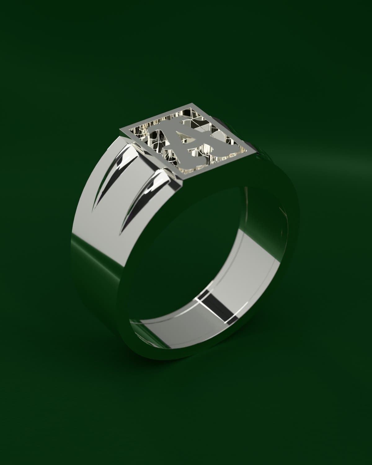 Render de un anillo sello en plata 925 con una inicial calada en la cara de arriba, sobre terciopelo verde